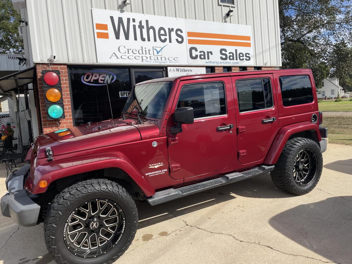 2013 Maroon /Black Jeep Wrangler Unlimited Sahara 4WD (1C4BJWEG8DL) with an 3.6L V6 DOHC 24V FFV engine, located at 204 Hwy. 16 East, Carthage, MS, 39051, (601) 267-7277, 0.000000, 0.000000 - Photo#0