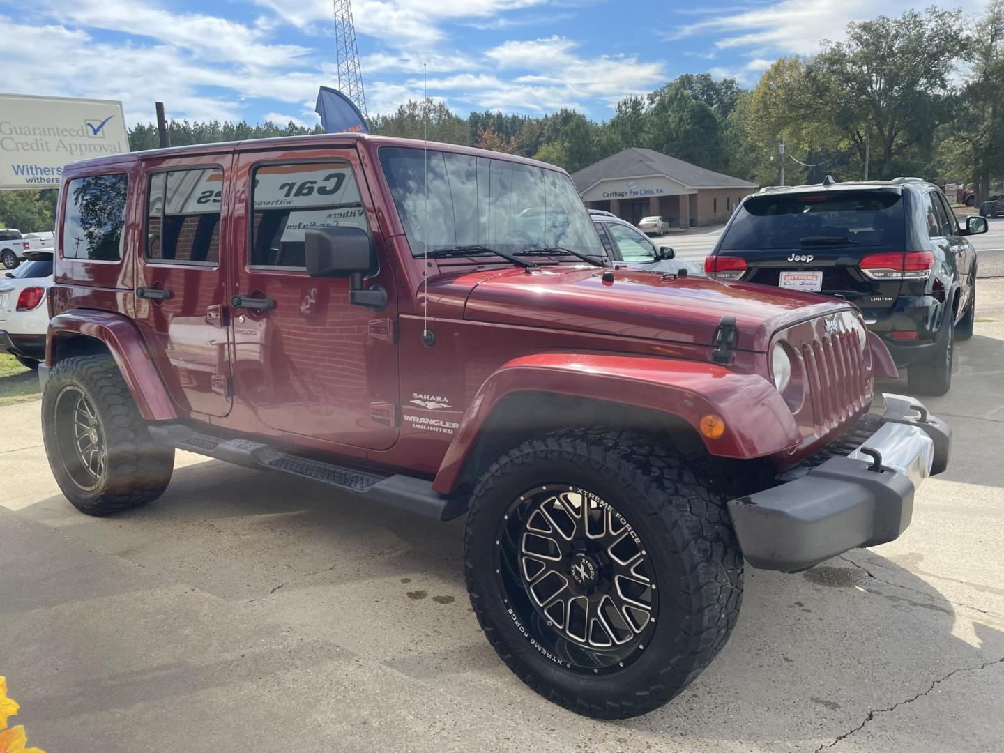 2013 Maroon /Black Jeep Wrangler Unlimited Sahara 4WD (1C4BJWEG8DL) with an 3.6L V6 DOHC 24V FFV engine, located at 204 Hwy. 16 East, Carthage, MS, 39051, (601) 267-7277, 0.000000, 0.000000 - Photo#1