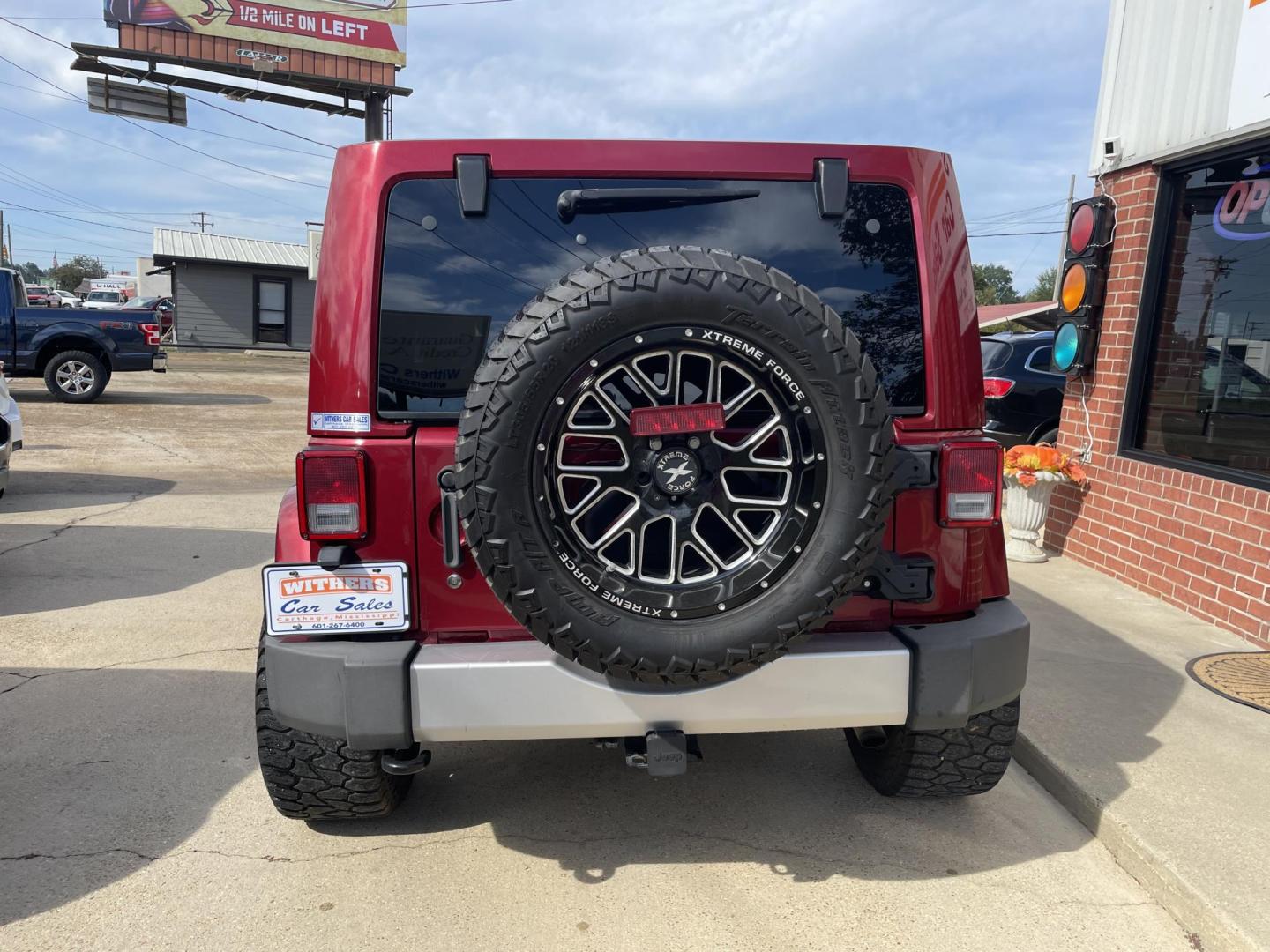 2013 Maroon /Black Jeep Wrangler Unlimited Sahara 4WD (1C4BJWEG8DL) with an 3.6L V6 DOHC 24V FFV engine, located at 204 Hwy. 16 East, Carthage, MS, 39051, (601) 267-7277, 0.000000, 0.000000 - Photo#3