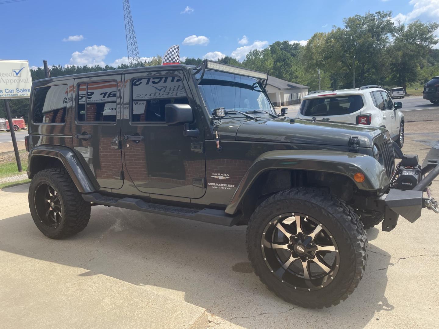 2015 Green /Black/Tan Jeep Wrangler Unlimited Sahara 4WD (1C4BJWEG4FL) with an 3.6L V6 DOHC 24V FFV engine, A transmission, located at 204 Hwy. 16 East, Carthage, MS, 39051, (601) 267-7277, 0.000000, 0.000000- Photo#1